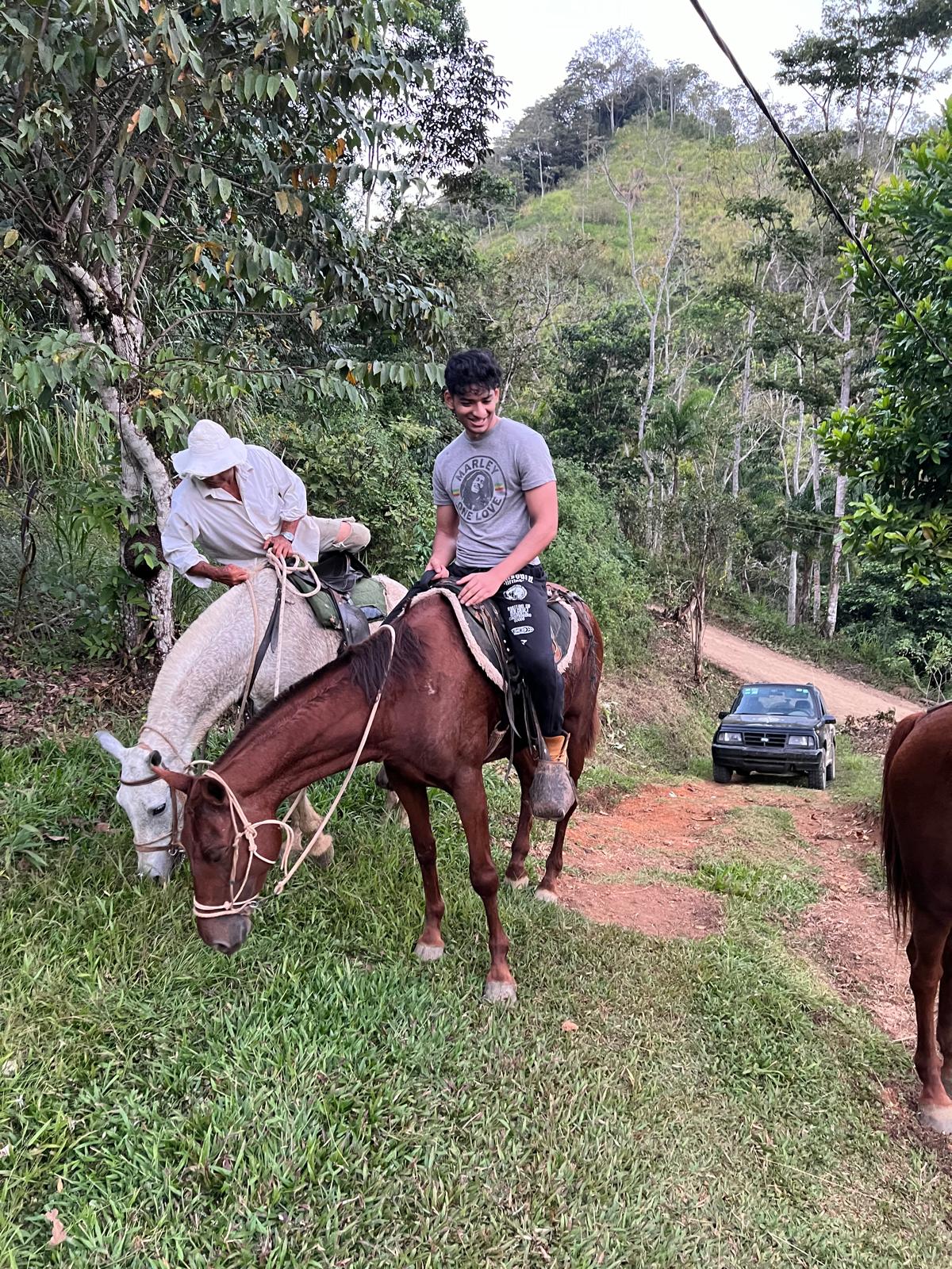 Guests horseback riding along the mountain road at Hacienda La Palma